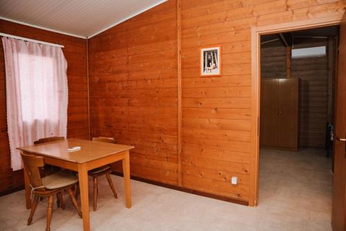 a wooden room with a table and a refrigerator at Village of Peace - House 34 in Shkodër
