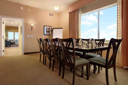 a dining room with a table and chairs and a window at Hilton Suites Ocean City Oceanfront in Ocean City
