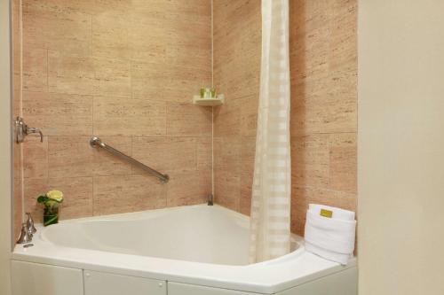 a bath tub in a bathroom with a shower at Hilton Suites Ocean City Oceanfront in Ocean City