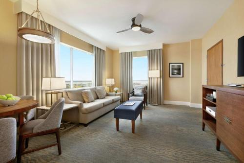 a living room with a couch and a table at Hilton Suites Ocean City Oceanfront in Ocean City