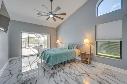 a bedroom with a bed and a ceiling fan at Luxurious Cape Coral Oasis Half Mi to Boat Ramp! in Cape Coral