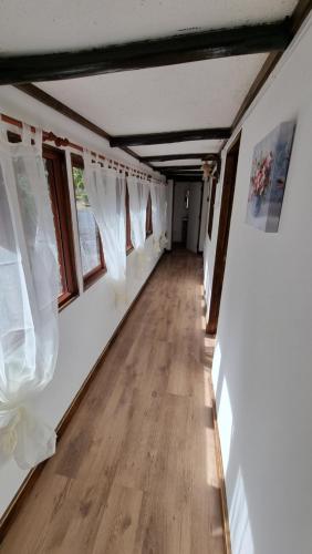 an empty room with white curtains and a wooden floor at ¡Cabaña full equipada para 6! in Guayacán