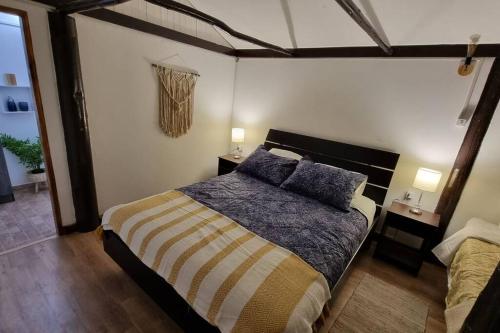 a bedroom with a bed with two pillows on it at ¡Cabaña full equipada para 6! in Guayacán