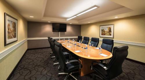 a conference room with a long table and chairs at Hilton Winnipeg Airport Suites in Winnipeg
