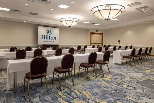 a conference room with white tables and chairs at Hilton Austin Airport in Austin