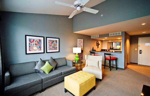 a living room with a couch and a kitchen at DoubleTree by Hilton Huntsville-South in Huntsville