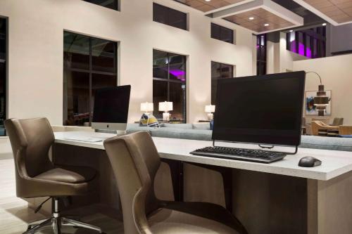 an office with a desk with a computer and two chairs at Embassy Suites by Hilton McAllen Convention Center in McAllen