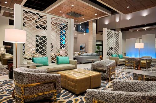a lobby with couches and chairs in a hotel at Embassy Suites by Hilton McAllen Convention Center in McAllen