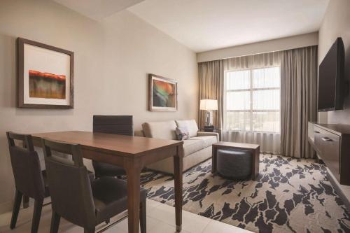 a living room with a table and a couch at Embassy Suites by Hilton McAllen Convention Center in McAllen