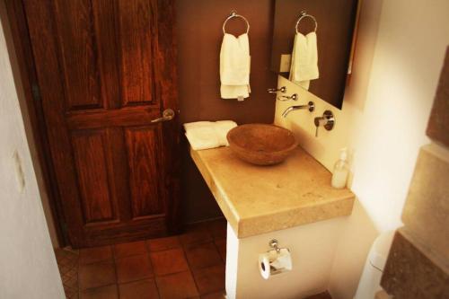a bathroom with a sink with a wooden bowl at Luxury at a great price in San Miguel in San Miguel de Allende