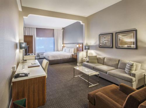 a hotel room with a couch and a bed at DoubleTree by Hilton Nanuet in Nanuet