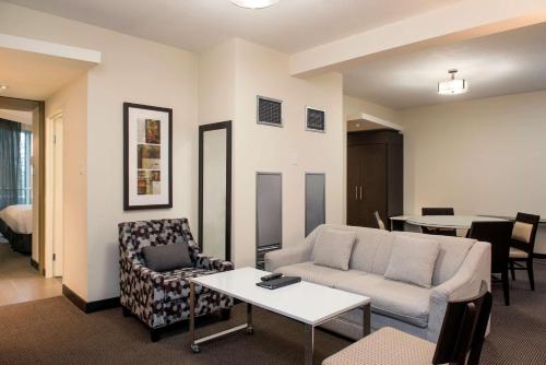 a living room with a couch and a table at Hilton Suites Toronto-Markham Conference Centre & Spa in Markham