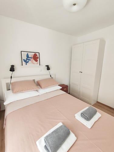 a bedroom with a large bed with two pillows on it at Apartment LIPA in Slatine