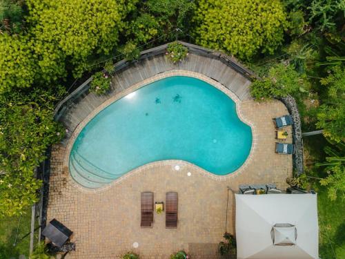 an overhead view of a swimming pool in a resort at The Ohia at The Koi House in Kailua-Kona