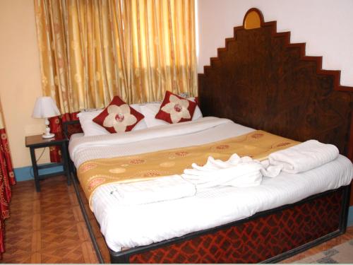 a bedroom with two beds with white sheets at Elbrus Home in Kathmandu