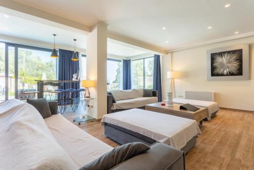 a living room with two beds and a couch at Villa Eleanna in Agnítsini