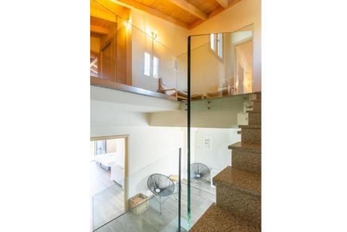 a staircase in a house with glass walls at Villa Eleanna in Agnítsini