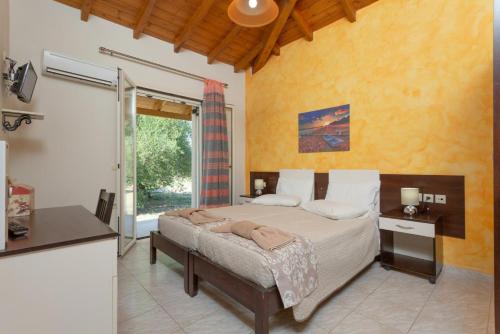 a bedroom with a bed and a large window at Villa Popi in Roda