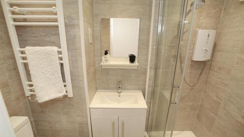 a bathroom with a sink and a shower at 9_304 Redcliffe Apartments, Caswell Bay in Bishopston