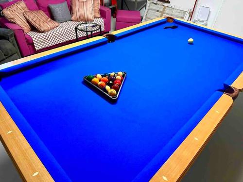 a pool table with a bowl of balls on it at GORGEOUS VIEW Pool, Park, Mall, Beaches, Airport in Plantation