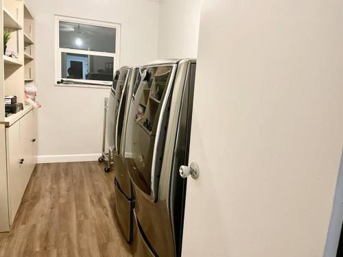 a group of refrigerators in a kitchen with a window at GORGEOUS VIEW Pool, Park, Mall, Beaches, Airport in Plantation