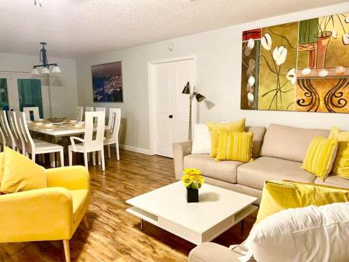a living room with a couch and a table at GORGEOUS VIEW Pool, Park, Mall, Beaches, Airport in Plantation