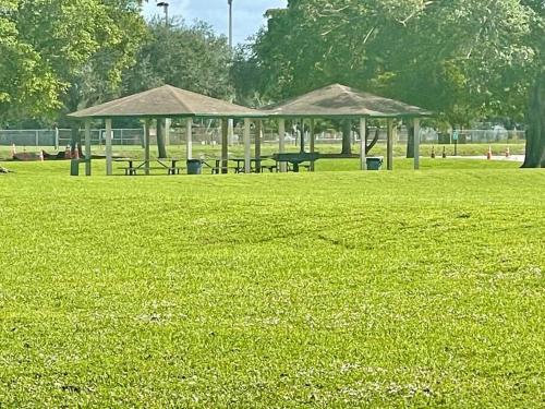a park with benches and a pavilion in the grass at GORGEOUS VIEW Pool, Park, Mall, Beaches, Airport in Plantation