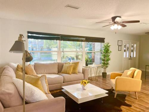 a living room with a couch and a table at GORGEOUS VIEW Pool, Park, Mall, Beaches, Airport in Plantation