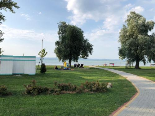a park with people sitting in the grass at Vadszilva Apartman in Balatonőszöd