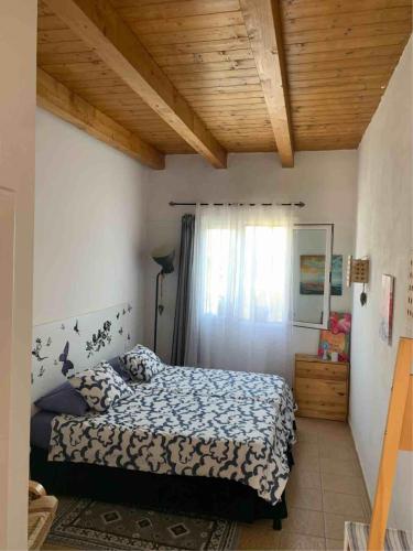 a bedroom with a bed and a wooden ceiling at joy in Lajares
