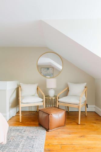 a living room with two chairs and a mirror at Quaint Boho Home in Lancaster City in Lancaster