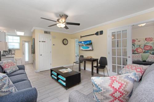 a living room with a couch and a ceiling fan at Clearwater Beach Suites 204 condo in Clearwater Beach