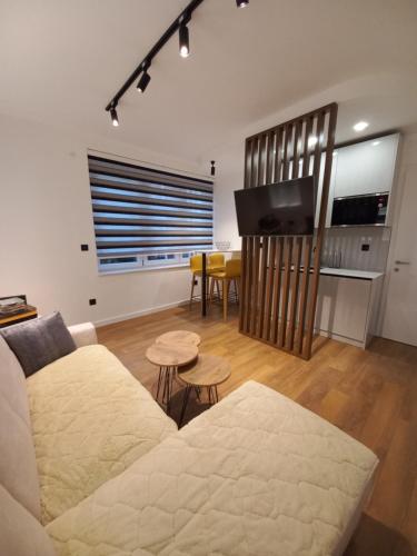 a living room with a couch and a flat screen tv at Heart of Sarajevo - Baščaršija Private Garage in Sarajevo