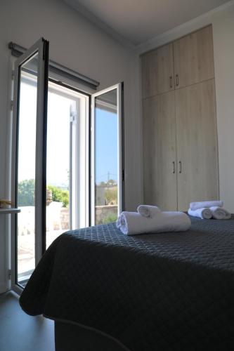 a bedroom with a bed with two towels on it at Serendipity Living in Kythira