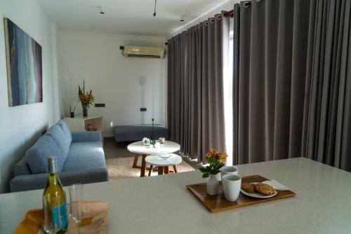 a living room with a blue couch and a table at Four Petals Inn in Colombo