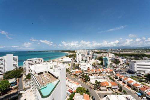 an aerial view of a city with the ocean at OCEAN VIEW DELUXE SUITE: PVT. BEACH & POOL in San Juan