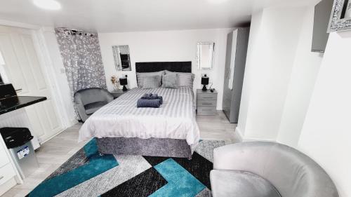 a bedroom with a large bed and a chair at Comfy Studio apartment with Wi-Fi and Smart TV in Leeds
