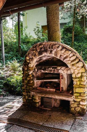 a stone pizza oven sitting on a patio at Ferienhaus Schetteregg in Egg