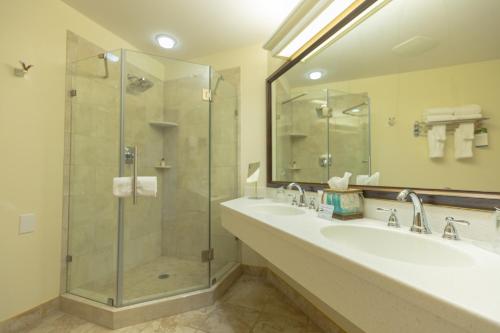 a bathroom with two sinks and a glass shower at Best Western Lodge at River's Edge in Orofino