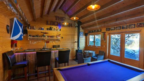 a pool table in a room with a bar at Cheltenham large house with gym, bar & hot tub in Golden Valley