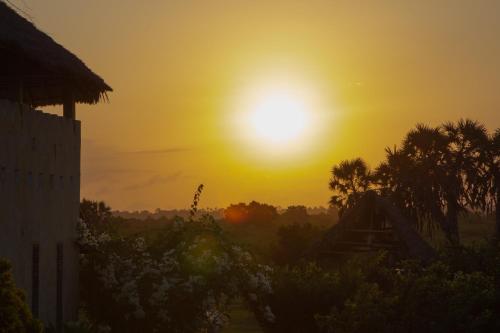 a sunset with the sun in the sky at Pangani Cliffs Lodge in Pangani