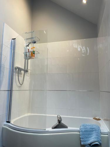 a bathroom with a shower and a bath tub at The Red Lodge Annexe in Woodborough