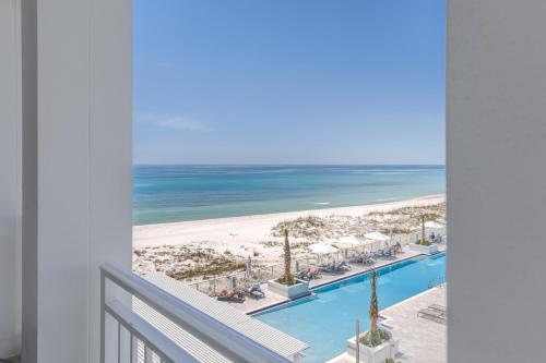 a view of the beach from the balcony of a resort at The Pensacola Beach Resort in Pensacola Beach