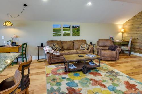 a living room with a couch and a table at Romantic, Cozy Loft with Yard, 5 Miles to Clemson in Central