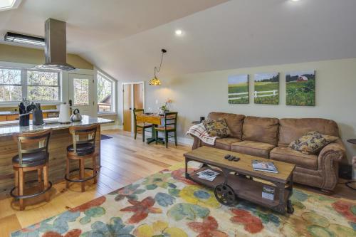 a living room with a couch and a table at Romantic, Cozy Loft with Yard, 5 Miles to Clemson in Central