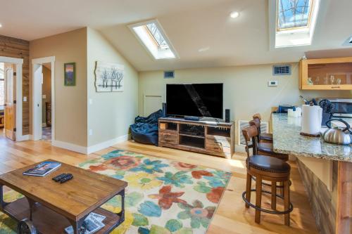 a living room with a flat screen tv and a table at Romantic, Cozy Loft with Yard, 5 Miles to Clemson in Central