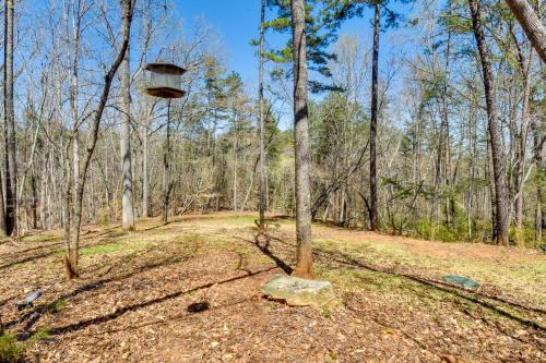 a bird feeder on a tree in the woods at Romantic, Cozy Loft with Yard, 5 Miles to Clemson in Central