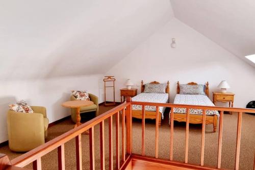 a room with two beds and a table and chairs at FlordeTajinaste in Puerto de la Cruz