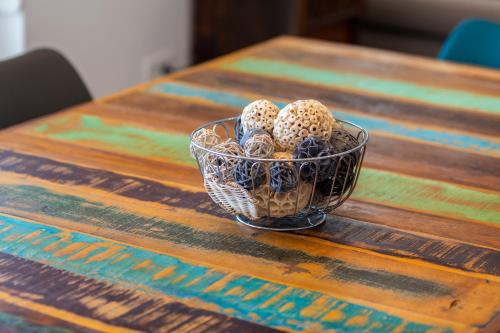 a glass bowl of eggs on a wooden table at Apartman Spin in Kastav