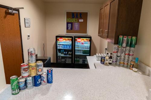a kitchen with a refrigerator filled with soda and drinks at Cobblestone Hotel & Suites-Sheldon in Sheldon